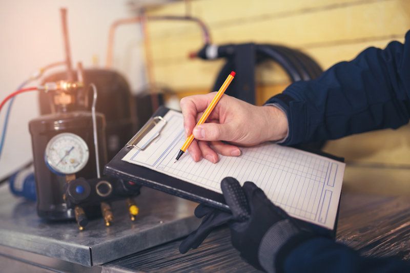 A HVAC tech uses a clipboard.How Do I Know When I Need a New Furnace?